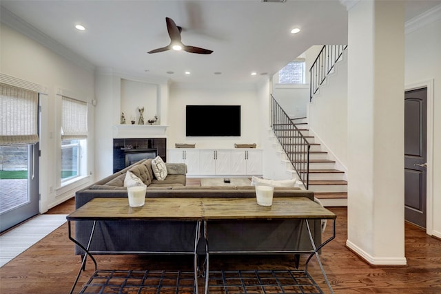 4004 Childress St, Houston, TX 77005 - living area featuring ornamental molding, stairs, a ceiling fan, a tiled fireplace, and recessed lighting