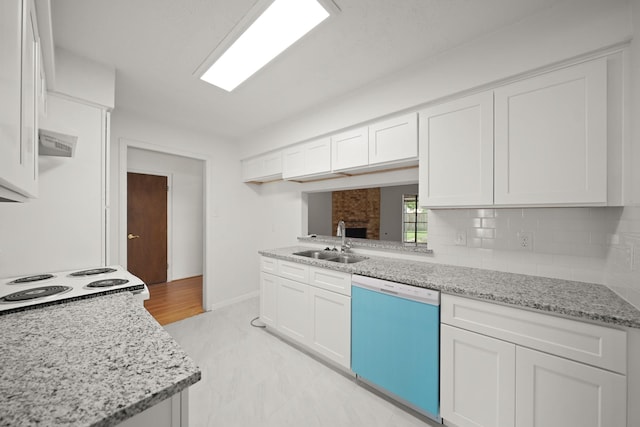 2531 Anzalone Dr, Spring, TX 77373 - kitchen with dishwasher, white cabinets, light stone countertops, and backsplash