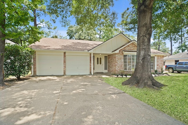 2531 Anzalone Dr, Spring, TX 77373 - ranch-style house featuring brick siding, concrete driveway, an attached garage, a front yard, and board and batten siding