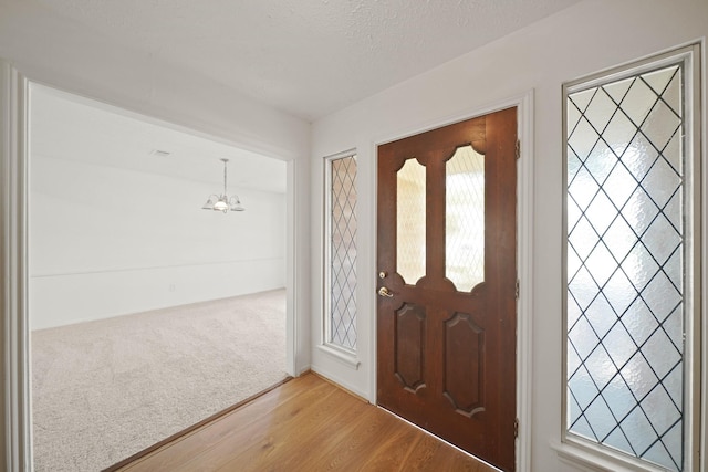 2531 Anzalone Dr, Spring, TX 77373 - foyer featuring a chandelier and wood finished floors