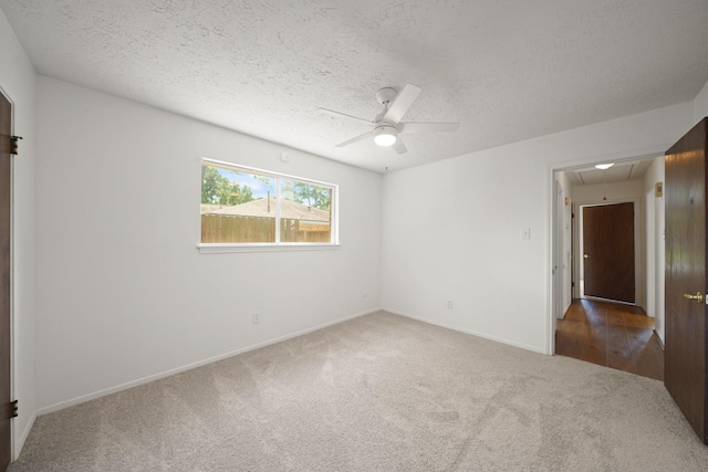 2531 Anzalone Dr, Spring, TX 77373 - unfurnished bedroom featuring attic access, carpet floors, a textured ceiling, and a ceiling fan