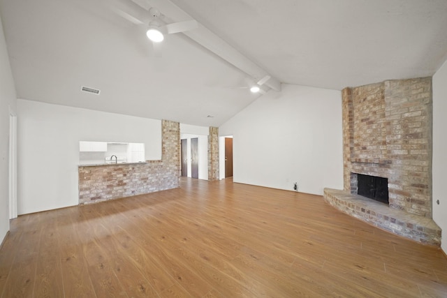 2531 Anzalone Dr, Spring, TX 77373 - unfurnished living room featuring a ceiling fan, hardwood / wood-style flooring, and a fireplace