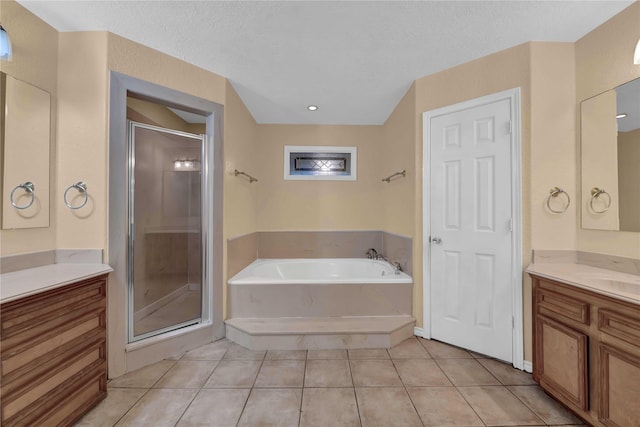 10802 4th 1/2 St, Santa Fe, TX 77510 - full bathroom featuring a shower stall, a bath, vanity, tile patterned floors, and a textured ceiling