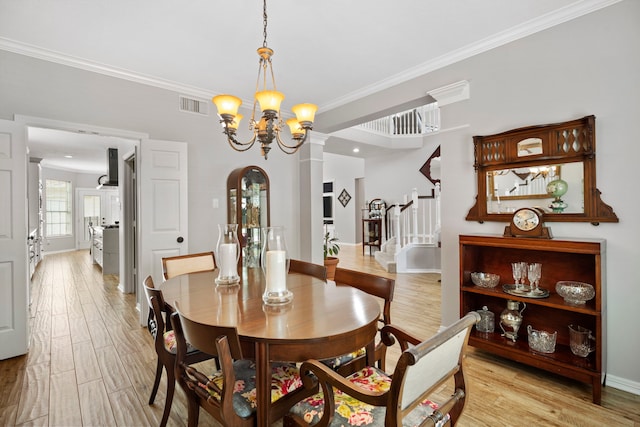 8522 Hillsboro Pl, Sugar Land, TX 77479 - dining area featuring crown molding, light wood-type flooring, stairs, and a chandelier