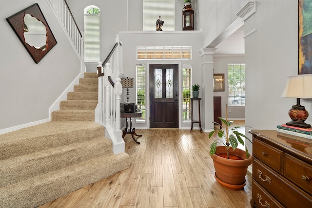 8522 Hillsboro Pl, Sugar Land, TX 77479 - entrance foyer with stairway, a towering ceiling, wood finished floors, and ornamental molding