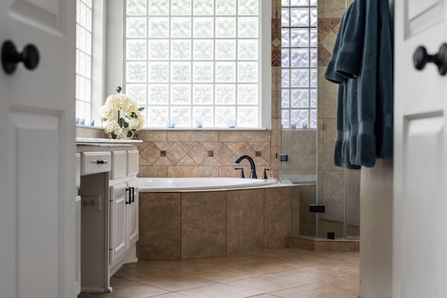8522 Hillsboro Pl, Sugar Land, TX 77479 - bathroom featuring a garden tub, tile patterned flooring, a stall shower, and vanity
