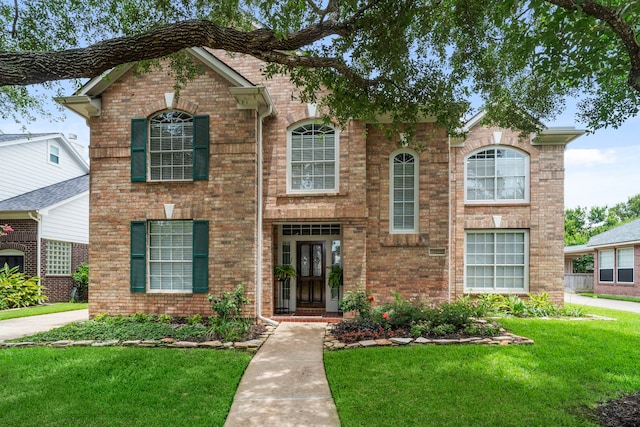 8522 Hillsboro Pl, Sugar Land, TX 77479 - traditional-style home with a front yard and brick siding