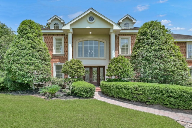15203 Wildwood Cir, Magnolia, TX 77354 - view of front of property featuring french doors, brick siding, and a front yard