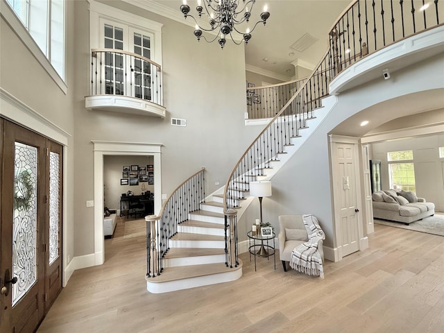 15203 Wildwood Cir, Magnolia, TX 77354 - entryway featuring a high ceiling, stairway, crown molding, wood finished floors, and arched walkways