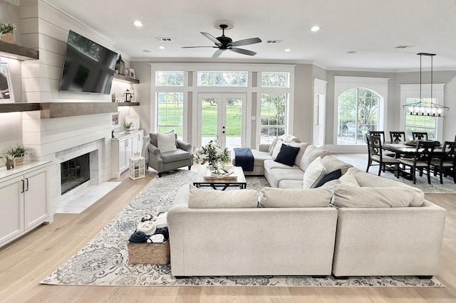 15203 Wildwood Cir, Magnolia, TX 77354 - living area with crown molding, ceiling fan, plenty of natural light, a high end fireplace, and recessed lighting