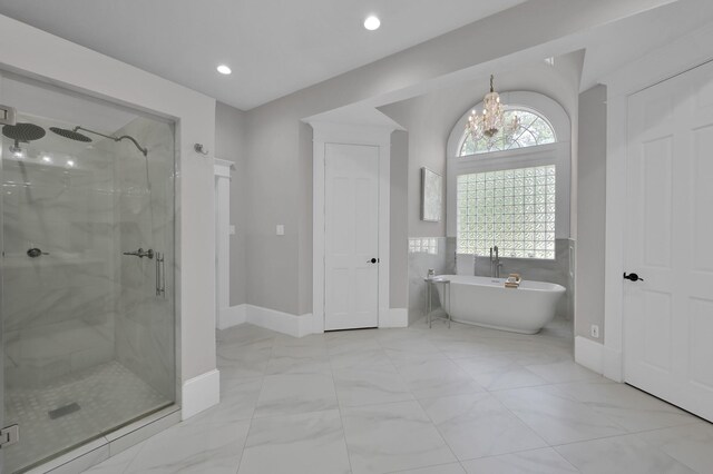 15203 Wildwood Cir, Magnolia, TX 77354 - bathroom featuring a marble finish shower, a soaking tub, a chandelier, marble look tiles, and recessed lighting