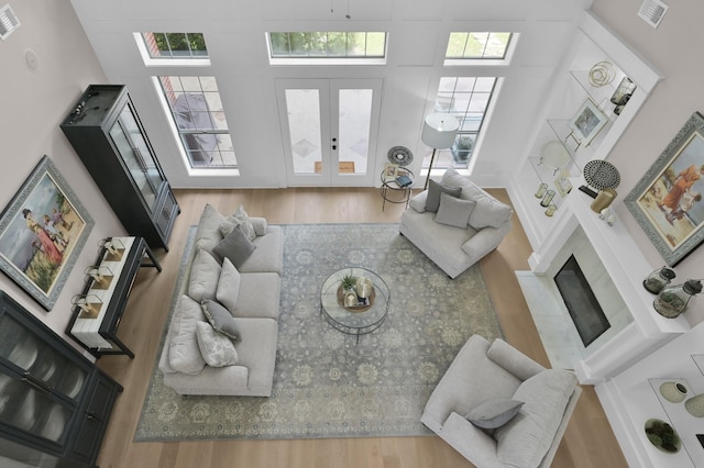 15203 Wildwood Cir, Magnolia, TX 77354 - living area featuring wood finished floors, french doors, and a high ceiling