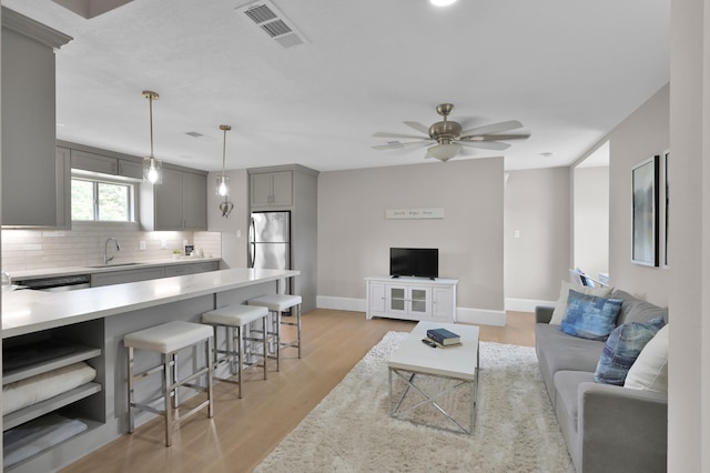 15203 Wildwood Cir, Magnolia, TX 77354 - living room featuring ceiling fan and light wood-style flooring