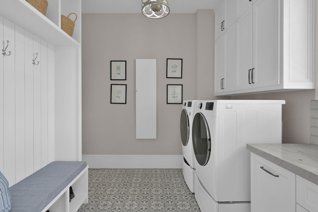 15203 Wildwood Cir, Magnolia, TX 77354 - laundry area featuring separate washer and dryer, cabinet space, and tile patterned floors
