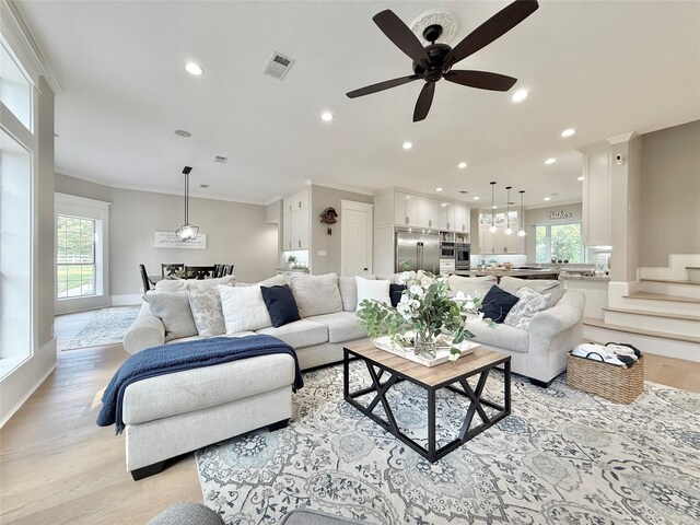 15203 Wildwood Cir, Magnolia, TX 77354 - living room with plenty of natural light, recessed lighting, light wood-type flooring, crown molding, and a ceiling fan