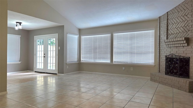 3018 Sherborne St, Pearland, TX 77584 - unfurnished living room featuring light tile patterned floors, vaulted ceiling, and a brick fireplace