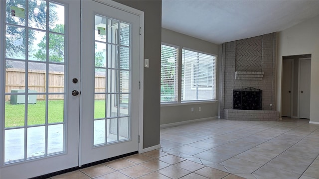 3018 Sherborne St, Pearland, TX 77584 - doorway featuring light tile patterned floors, a fireplace, vaulted ceiling, and french doors