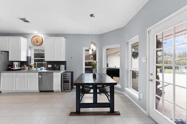 4807 Louisa Ct, Sugar Land, TX 77478 - kitchen with stainless steel dishwasher, beverage cooler, healthy amount of natural light, and tasteful backsplash