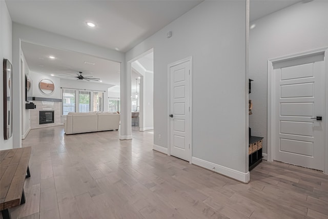30706 Southern Dewberry Ct, Fulshear, TX 77441 - unfurnished living room with ceiling fan, light wood-style floors, a fireplace, and recessed lighting