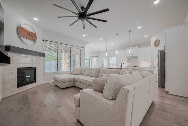 30706 Southern Dewberry Ct, Fulshear, TX 77441 - living area with wood finished floors, plenty of natural light, a ceiling fan, recessed lighting, and a tile fireplace