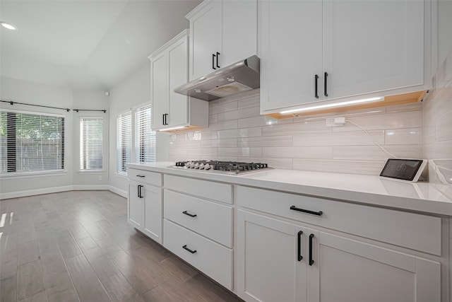 30706 Southern Dewberry Ct, Fulshear, TX 77441 - kitchen featuring stainless steel gas cooktop, under cabinet range hood, decorative backsplash, light countertops, and white cabinets