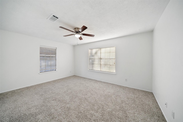 12417 Pegasus Dr, Willis, TX 77318 - unfurnished room with carpet flooring, ceiling fan, and plenty of natural light