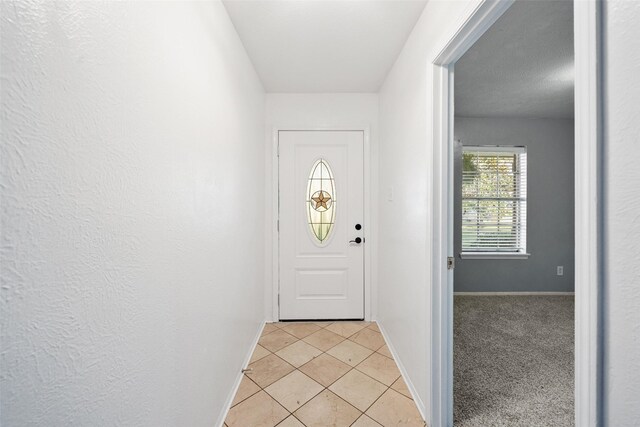 12417 Pegasus Dr, Willis, TX 77318 - doorway to outside featuring light tile patterned flooring and baseboards