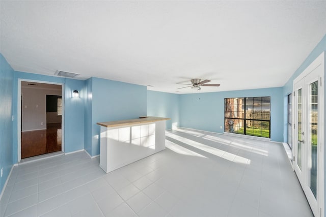 12417 Pegasus Dr, Willis, TX 77318 - tiled spare room with a ceiling fan and baseboards