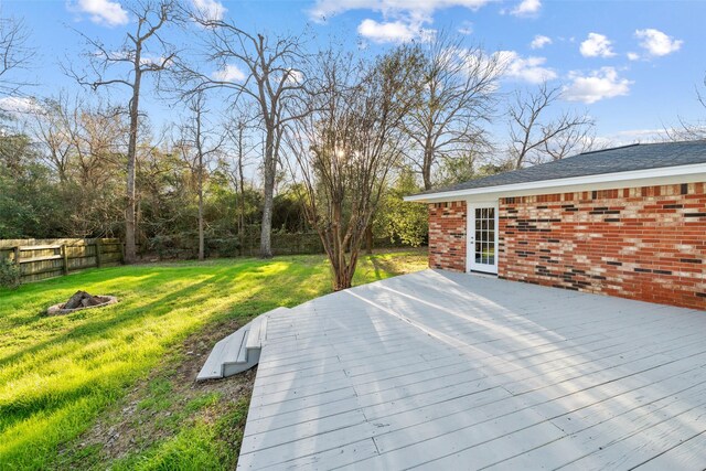 12417 Pegasus Dr, Willis, TX 77318 - wooden deck with an outdoor fire pit