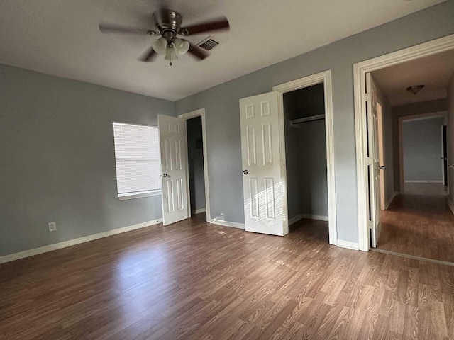 1826 Wayside Dr, Texas City, TX 77590 - unfurnished bedroom featuring dark wood finished floors, a closet, and a ceiling fan