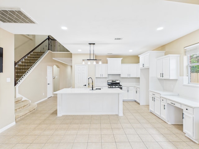 16911 Wortley Dr, Houston, TX 77084 - kitchen featuring stainless steel gas range, a center island with sink, light countertops, white cabinetry, and recessed lighting