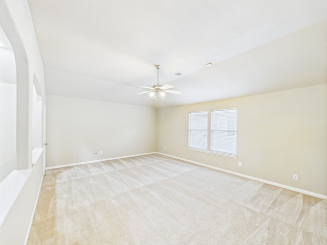 16911 Wortley Dr, Houston, TX 77084 - spare room featuring light colored carpet, ceiling fan, arched walkways, and vaulted ceiling