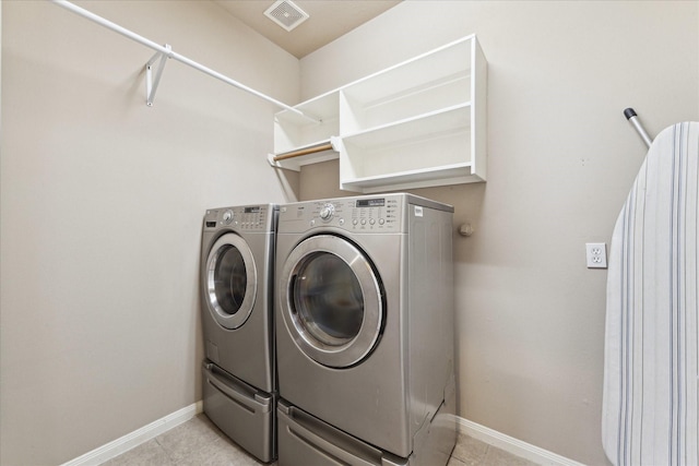 16911 Wortley Dr, Houston, TX 77084 - laundry room featuring washing machine and clothes dryer and light tile patterned flooring