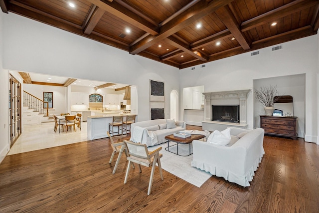 1039 Kirby Dr, Houston, TX 77019 - living room with wood finished floors, a wooden ceiling with exposed beams, stairs, coffered ceiling, and recessed lighting