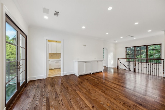 1039 Kirby Dr, Houston, TX 77019 - unfurnished room with healthy amount of natural light, wood finished floors, recessed lighting, french doors, and arched walkways