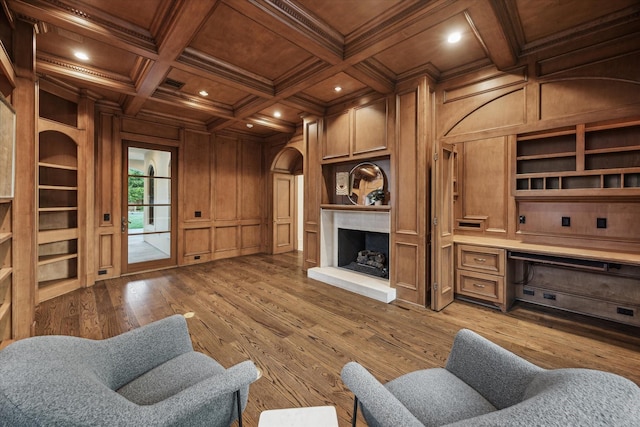 1039 Kirby Dr, Houston, TX 77019 - living area featuring a wood ceiling with exposed beams, ornamental molding, built in shelves, a decorative wall, and light wood-style flooring