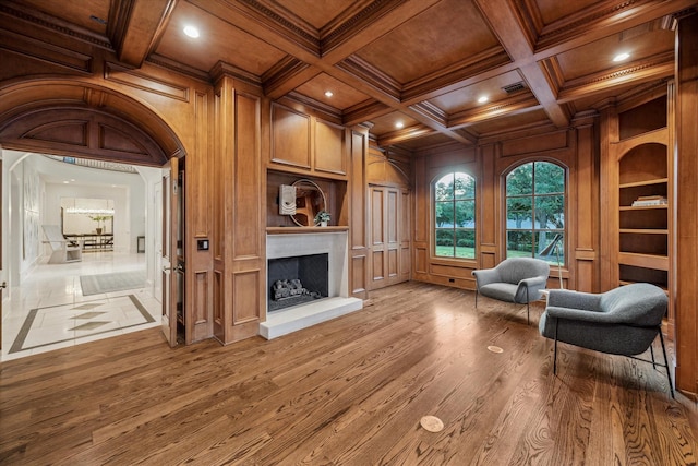 1039 Kirby Dr, Houston, TX 77019 - sitting room with a wood ceiling with exposed beams, a fireplace with raised hearth, crown molding, recessed lighting, and a decorative wall