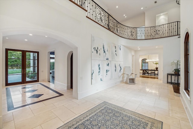 1039 Kirby Dr, Houston, TX 77019 - entryway with arched walkways, recessed lighting, a high ceiling, and crown molding