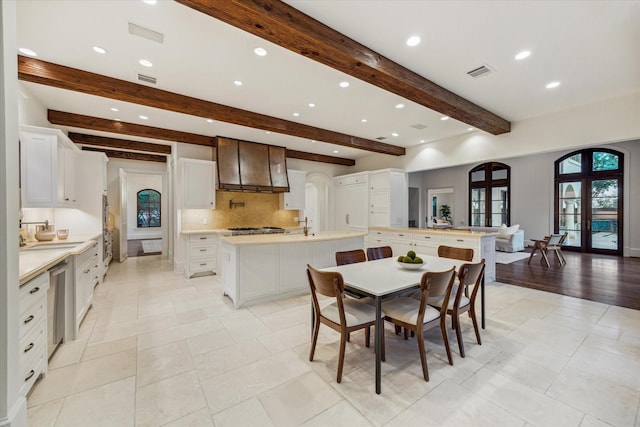 1039 Kirby Dr, Houston, TX 77019 - dining area with recessed lighting, beamed ceiling, and french doors