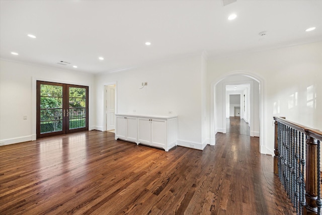 1039 Kirby Dr, Houston, TX 77019 - spare room featuring arched walkways, crown molding, dark wood-style flooring, and recessed lighting