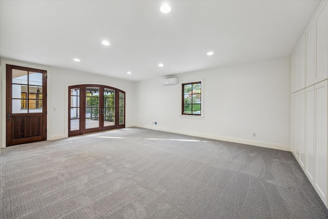 1039 Kirby Dr, Houston, TX 77019 - unfurnished living room with a wall unit AC, carpet floors, recessed lighting, healthy amount of natural light, and french doors