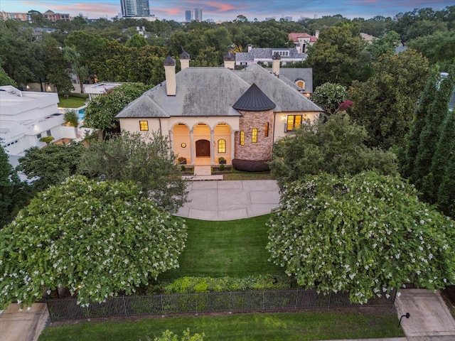 1039 Kirby Dr, Houston, TX 77019 - french country home with a chimney, stone siding, and stucco siding