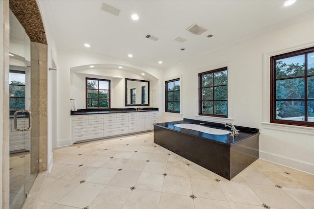 1039 Kirby Dr, Houston, TX 77019 - bathroom featuring double vanity, a bath, recessed lighting, and ornamental molding
