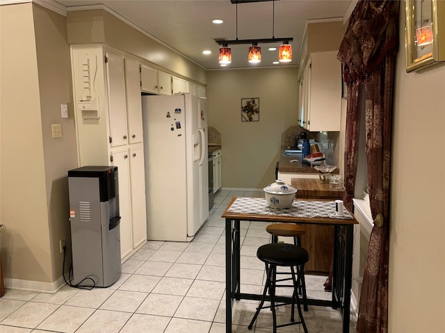 2709 8th Ave N, Texas City, TX 77590 - kitchen with white fridge with ice dispenser, crown molding, light tile patterned floors, and recessed lighting