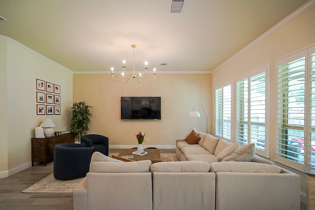 13114 Sierra National Dr, Humble, TX 77346 - living area with healthy amount of natural light, a chandelier, ornamental molding, and wood finished floors