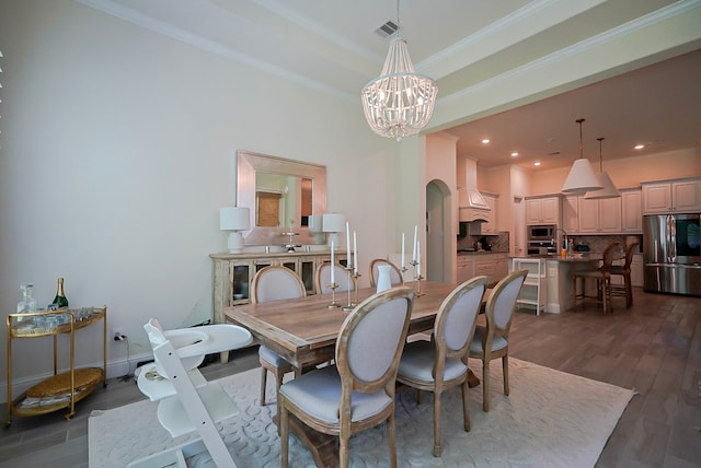 13114 Sierra National Dr, Humble, TX 77346 - dining area with a chandelier, dark wood-type flooring, ornamental molding, arched walkways, and recessed lighting