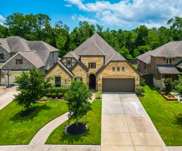 13114 Sierra National Dr, Humble, TX 77346 - view of front of property with stone siding, concrete driveway, a front lawn, and a garage