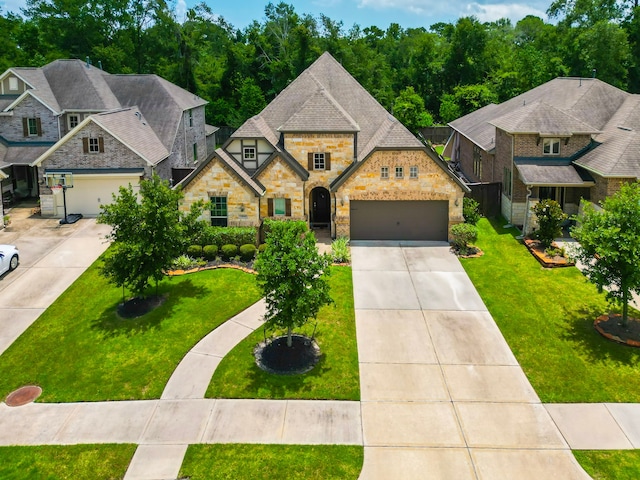 13114 Sierra National Dr, Humble, TX 77346 - french provincial home with stone siding, driveway, a front yard, and a garage