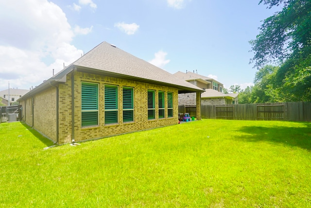 13114 Sierra National Dr, Humble, TX 77346 - back of house with brick siding, a fenced backyard, and roof with shingles