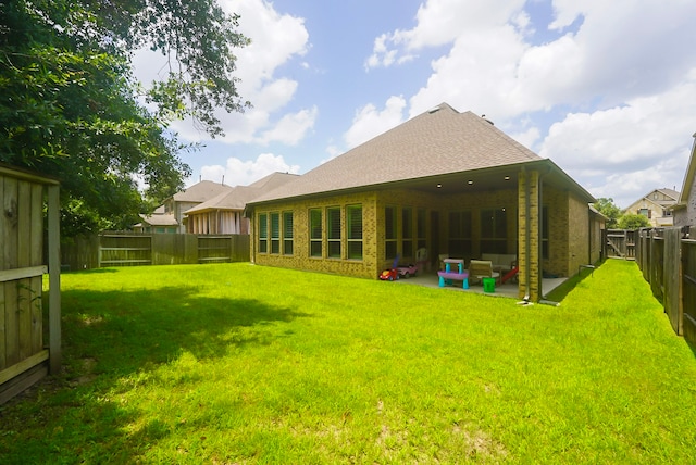 13114 Sierra National Dr, Humble, TX 77346 - back of house with brick siding, a fenced backyard, a patio, and a shingled roof